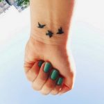 Flying birds wrist tattoo