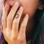 Half moon tattoo on finger